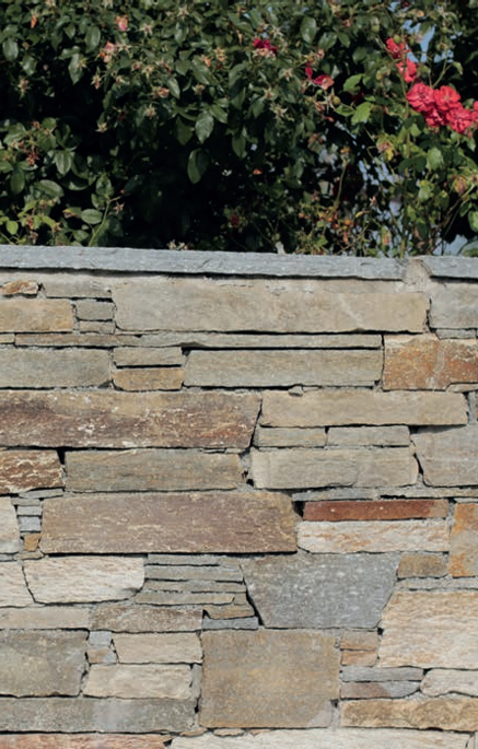Natural split cladding installed wall